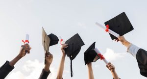 Master's degree certificate and group of hands in sky with winning success in college education. Learning, knowledge and winner future, celebration of study achievement and graduate holding paper in air