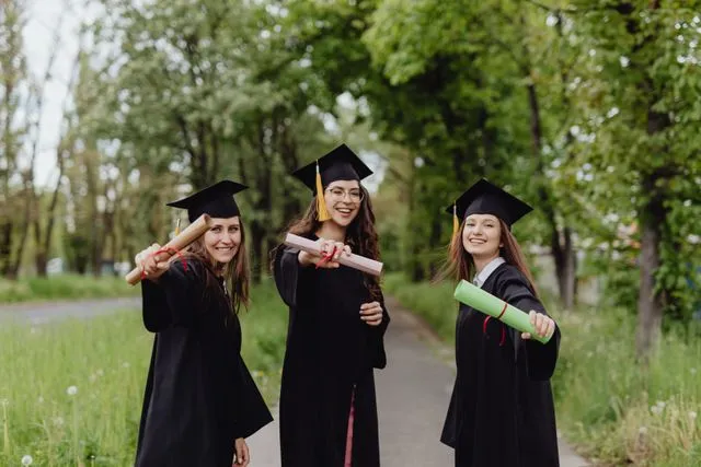 Graduate students celebrating graduation for study abroad and GRE preparation