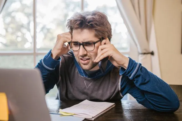 Student facing GRE preparation challenges while studying with laptop and notes